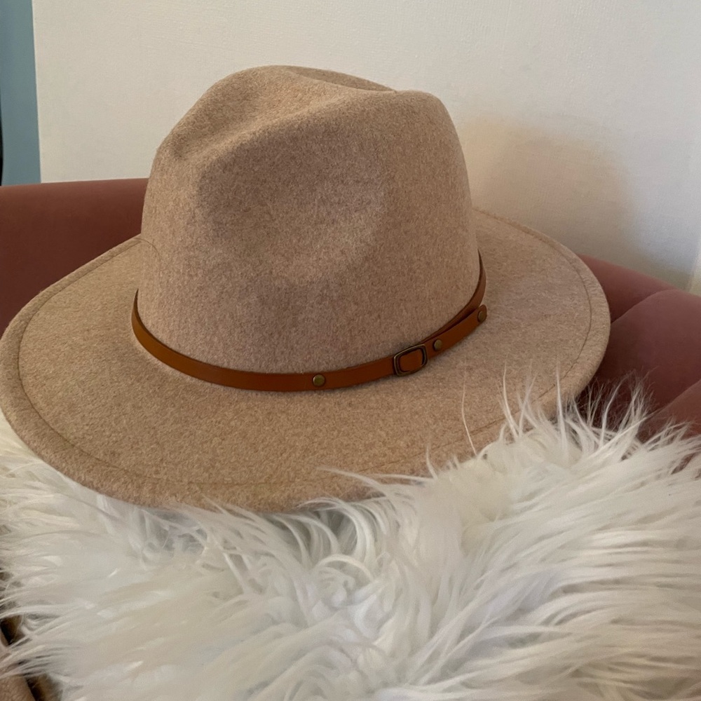 Tan hat with brown buckle, adjustable inside gently used